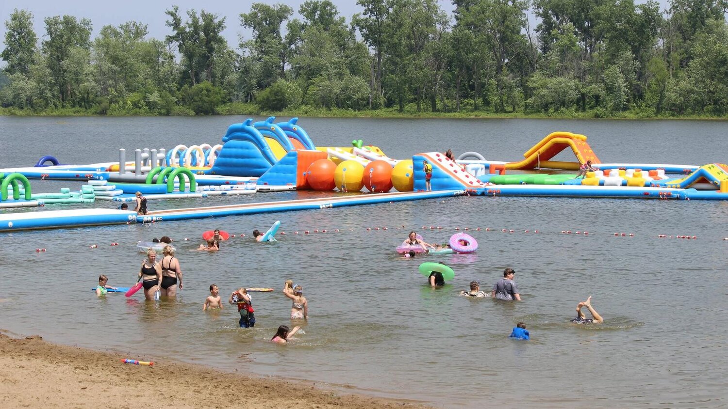 Inflatable water park with floating obstacles at Lazy L Lake near Terre Haute