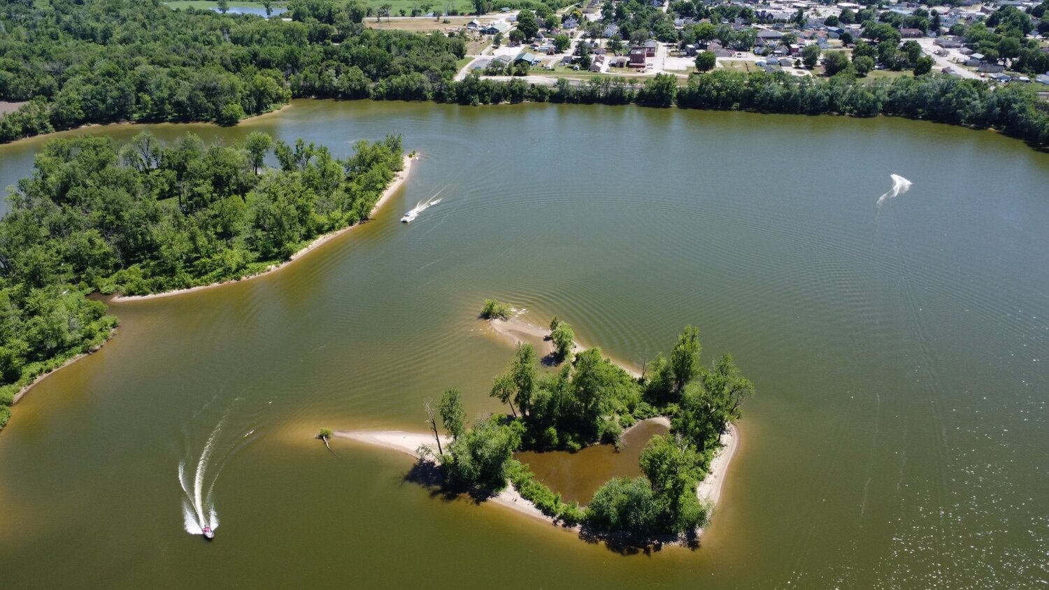 Island and calm water on the lake at Lazy L Lake Campground