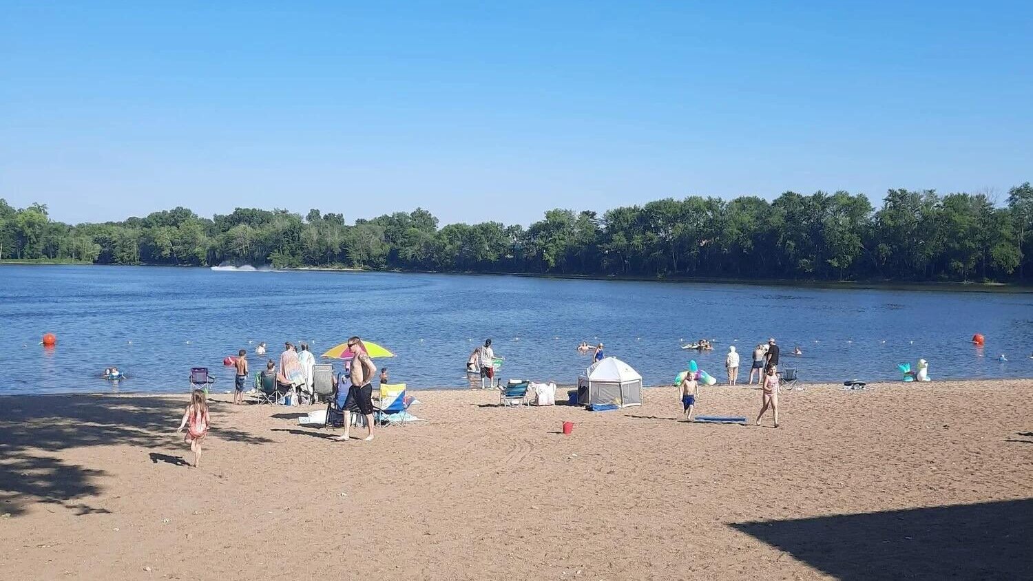 Sandy swimming beach at Lazy L Lake Campground